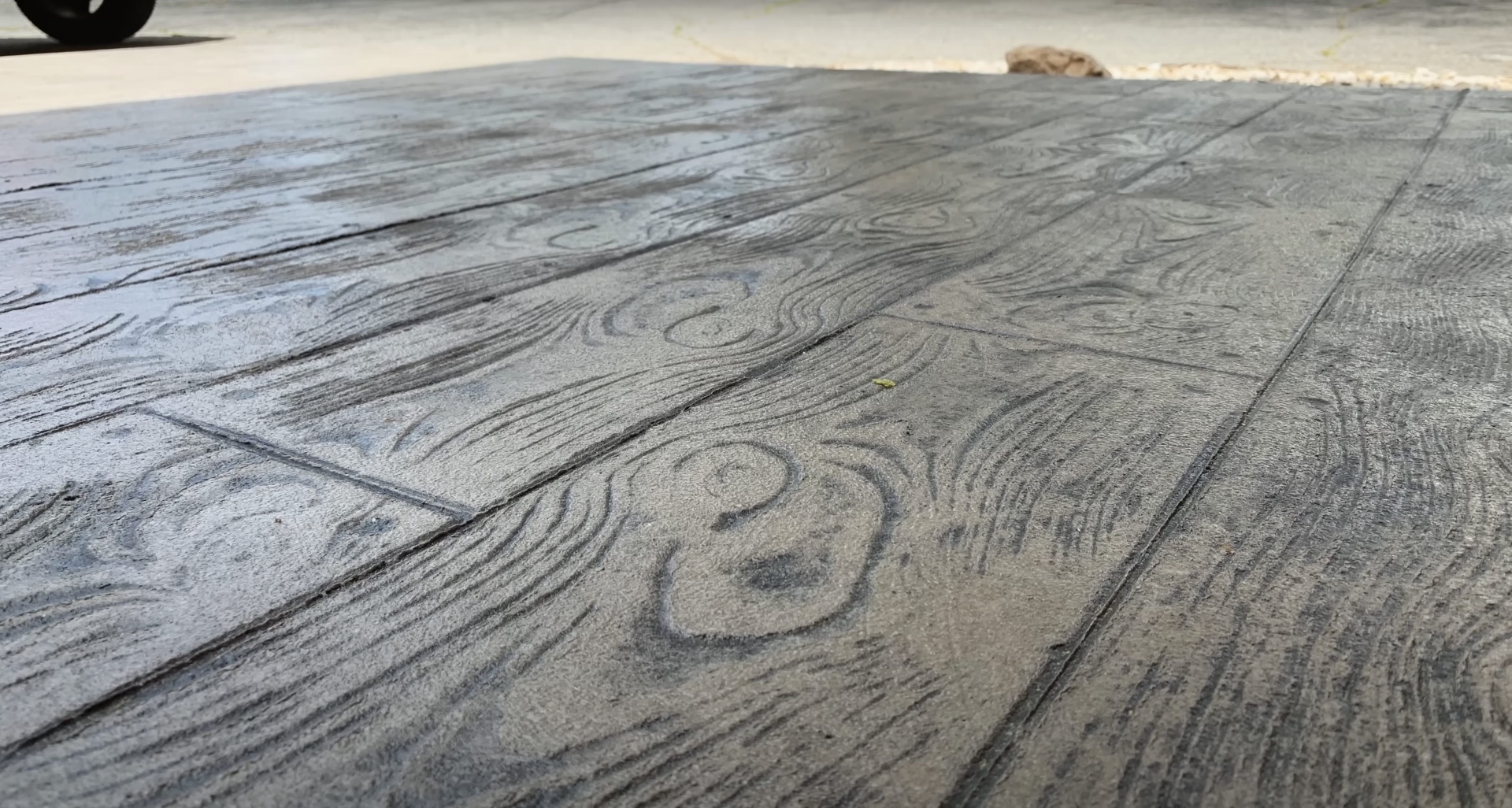 Stamped decorative concrete with wood grain pattern installed by professional contractors