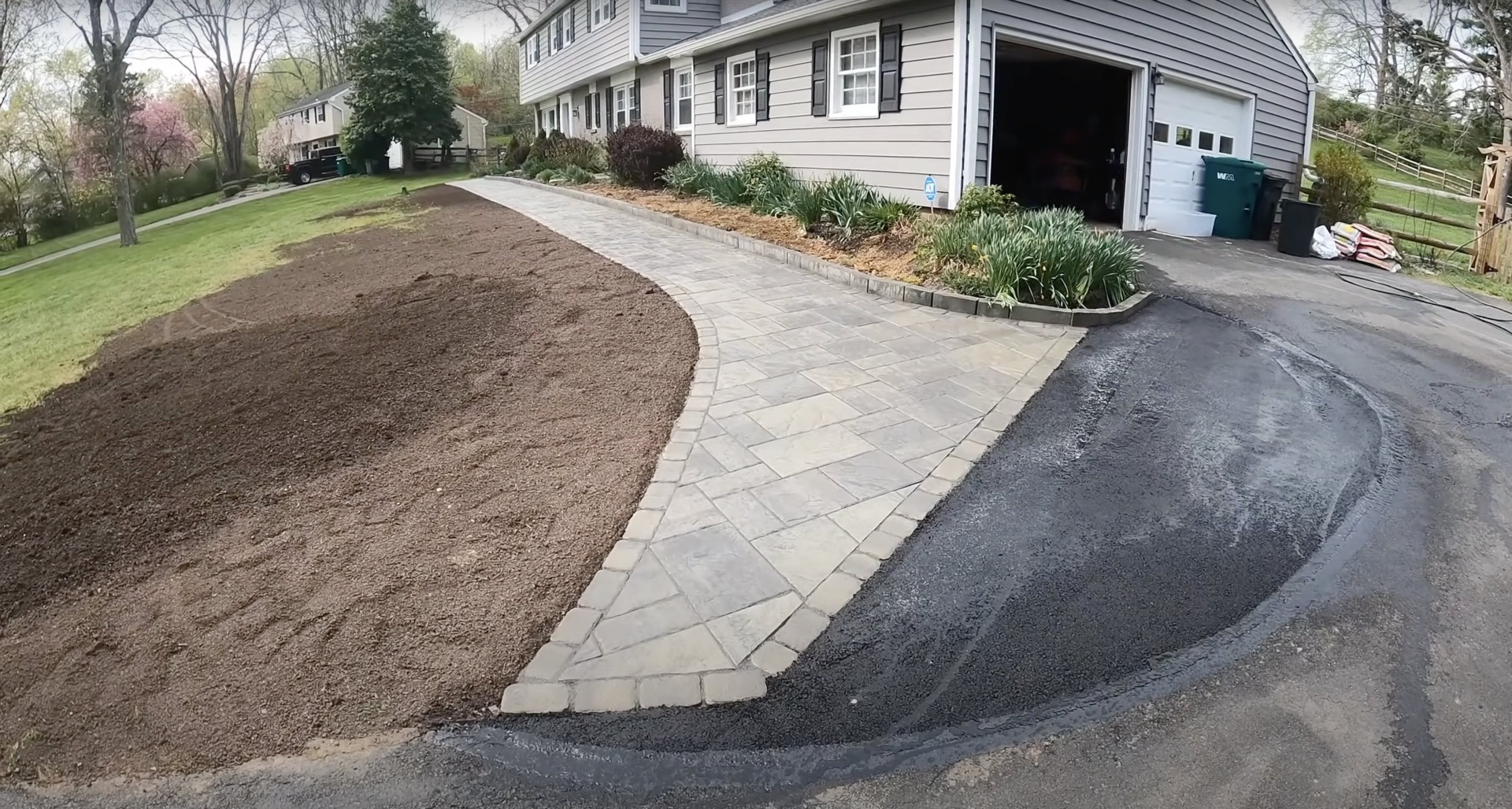 Curved stamped concrete walkway connecting driveway to home entrance