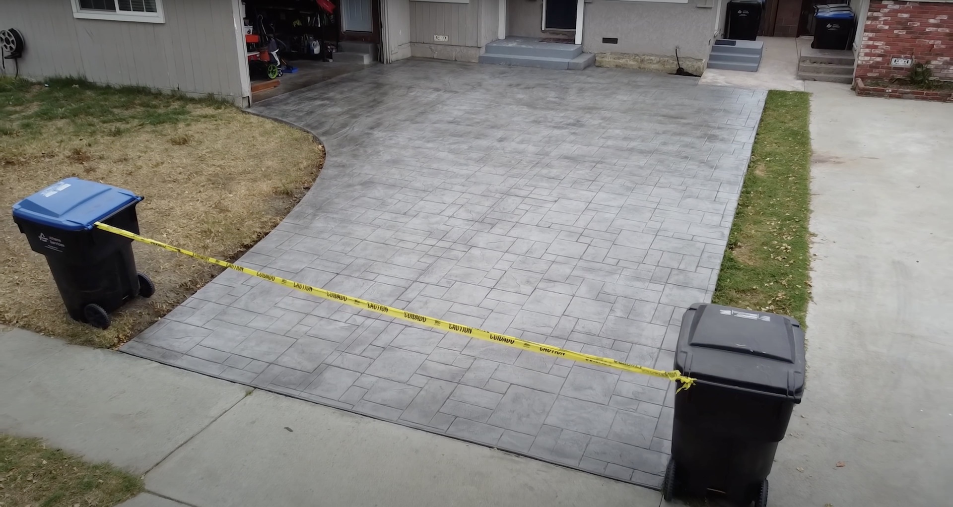 Stamped concrete patio with decorative paver pattern in residential setting
